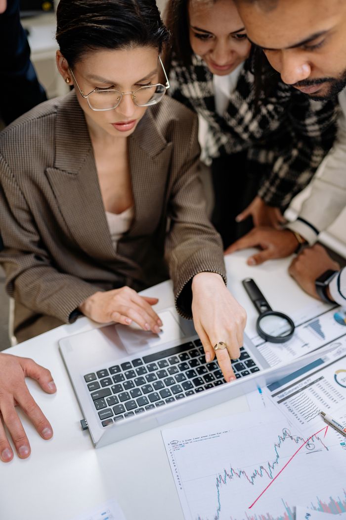 Mastering the First Impression: Your intriguing post title goes here Business team analyzing financial graphs on a laptop during a collaborative meeting.